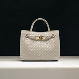 Cream woven leather handbag with gold knot clasp and top handle – luxury designer bag