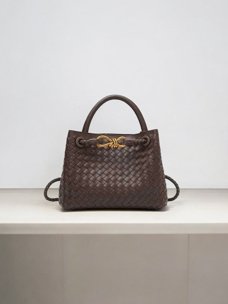 Dark brown woven leather handbag with gold knot clasp and top handle