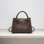 Dark brown woven leather handbag with gold knot clasp and top handle
