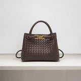 Dark brown woven leather handbag with gold knot clasp and top handle