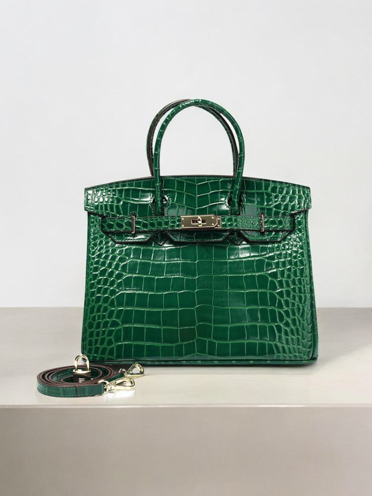 Emerald green crocodile-embossed leather handbag with gold hardware and detachable strap