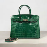 Emerald green crocodile-embossed leather handbag with gold hardware and detachable strap