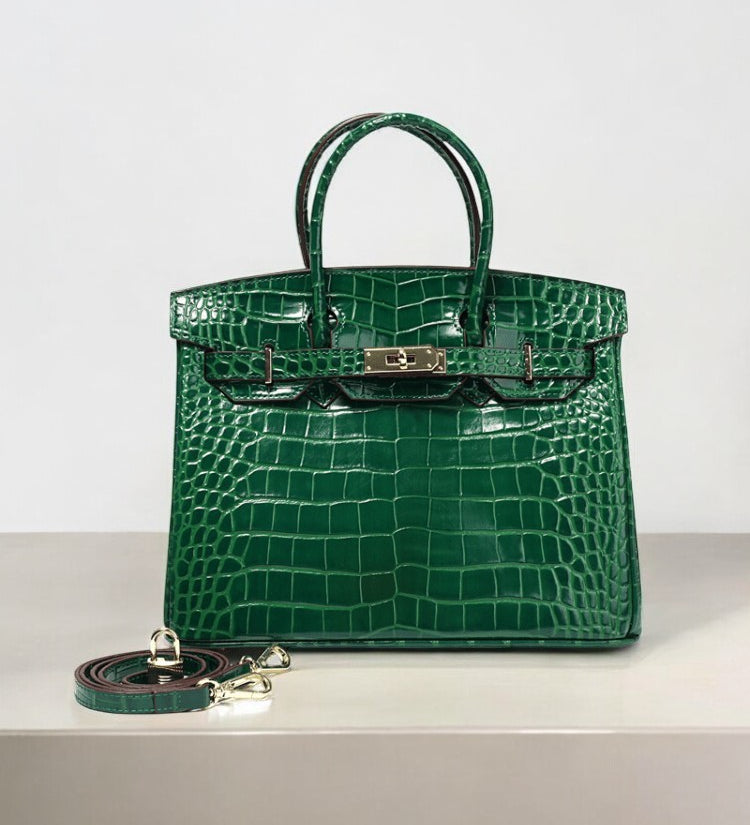 Emerald green crocodile-embossed leather handbag with gold hardware and detachable strap