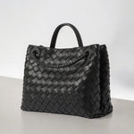 Black woven leather tote bag with braided shoulder strap and top handle - Aurora-bags.com

