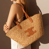 Women's Vintage Straw Woven Tote Bag with Leather Handles and Decorative Emblem